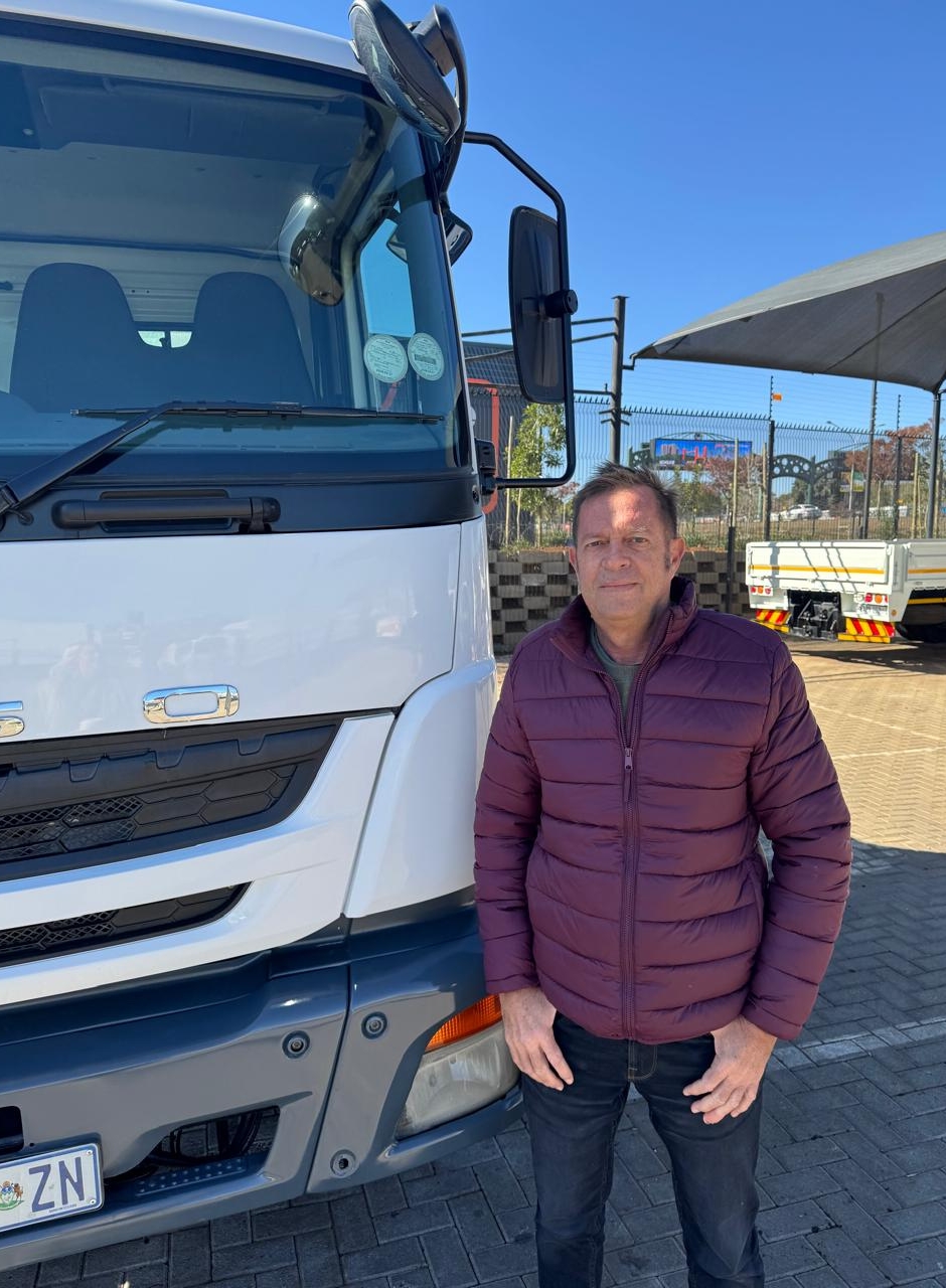Cobus Lourens of CLC Trucks standing confidently in front of a heavy duty truck, symbolizing reliable commercial vehicle expertise.