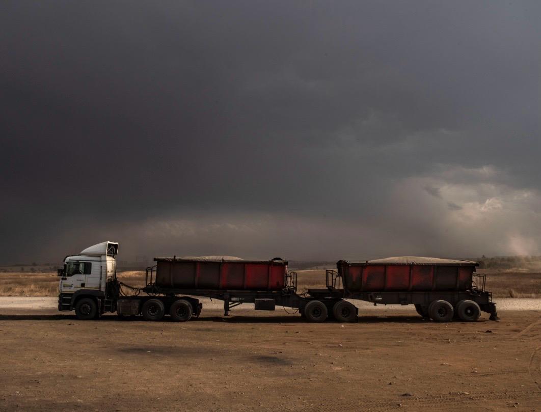 CLC Trucks provides a June 2026 update about the June Fuel update and showing appreciation to Truck Drivers. A commercial transport truck facing severe, dark winter storm clouds on an open South African route, illustrating the daily sacrifices and dangers truck drivers experience.